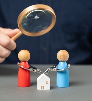 Wooden figures of a man woman and their house